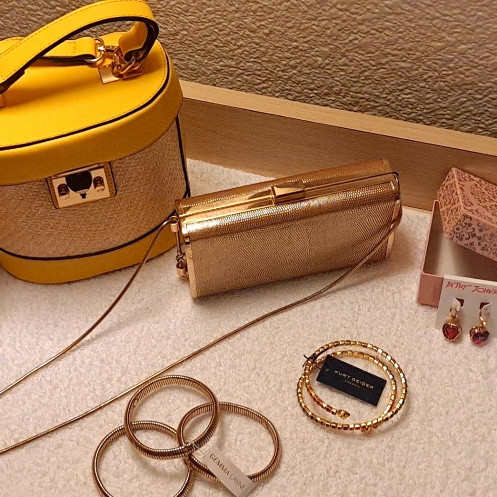 Sheek fashion forward rose gold clutch and yellow leather handbag.